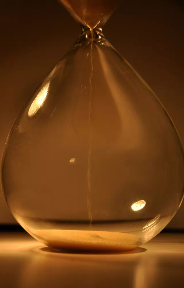 a close up of an hourglass on a table
