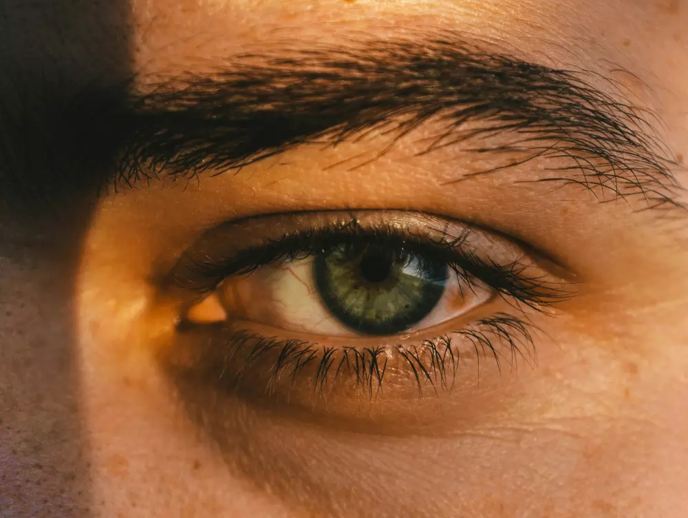 a close up of a person's green eye