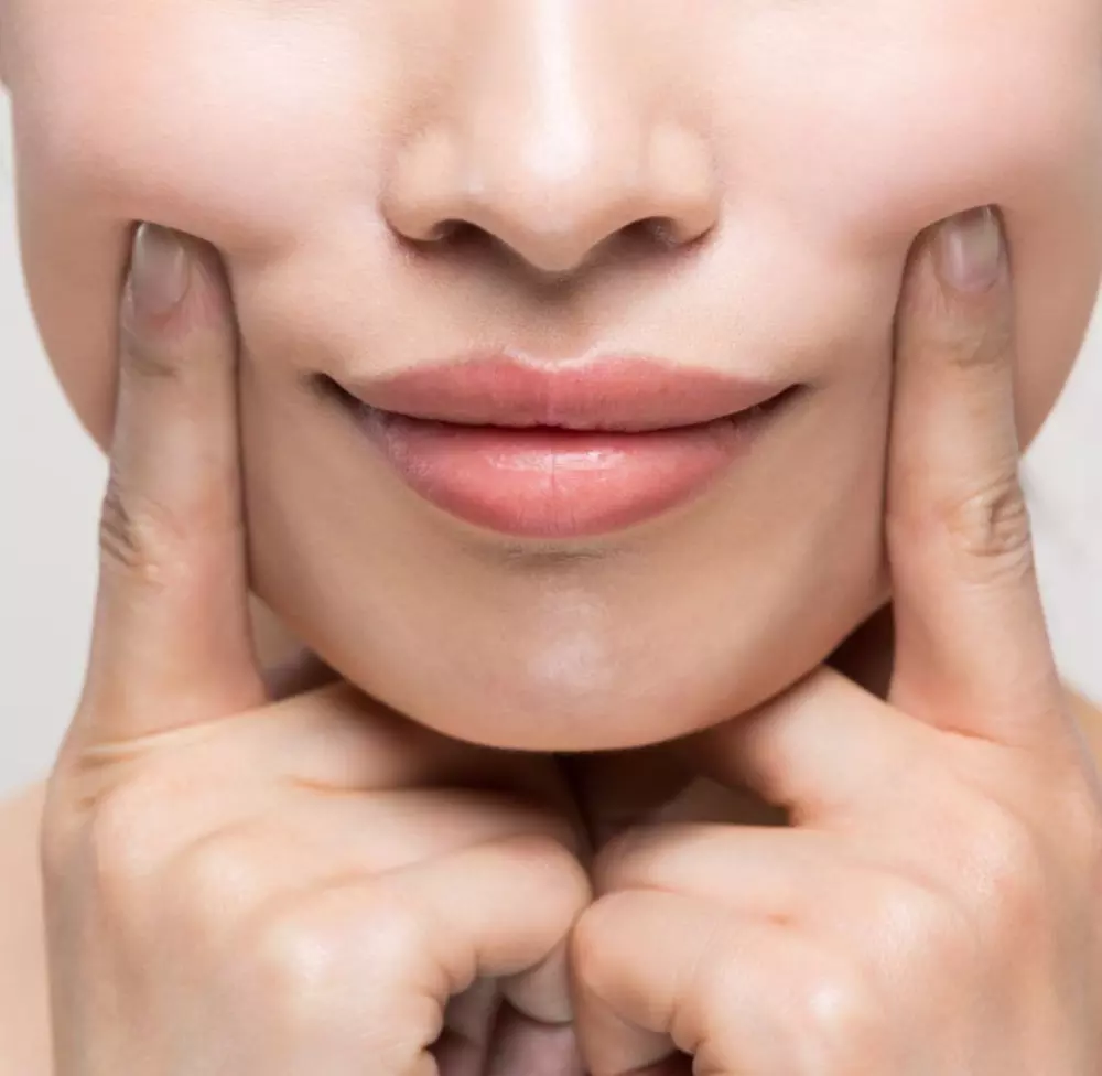 a woman with her hands on her face