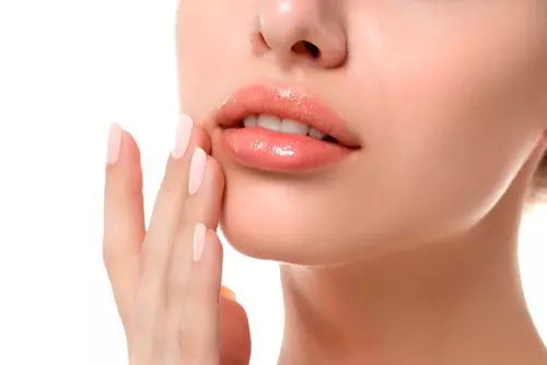 a woman is putting her hand on her lips