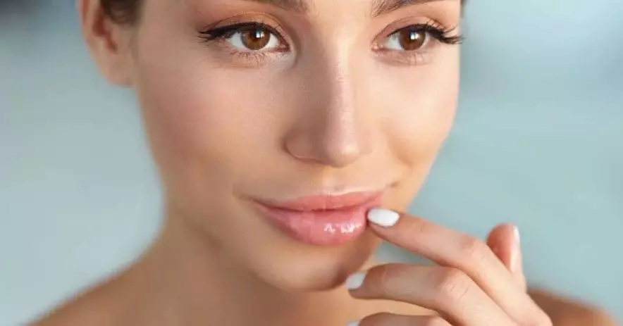 a woman is putting her finger on her lips