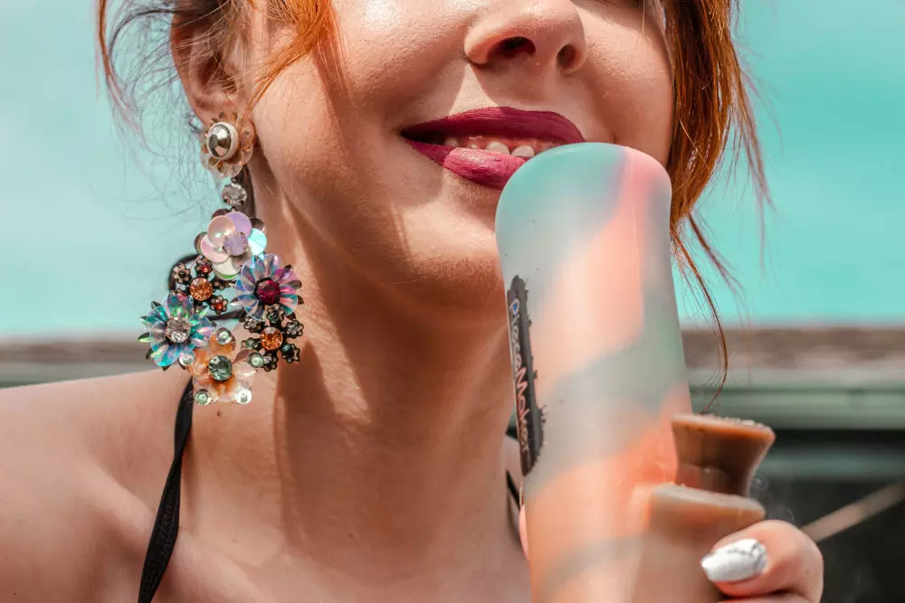 a woman holding an ice cream cone in her hand
