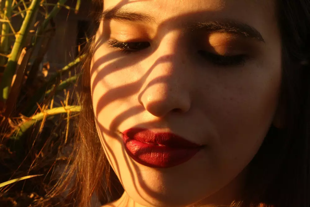 a close up of a woman with her eyes closed
