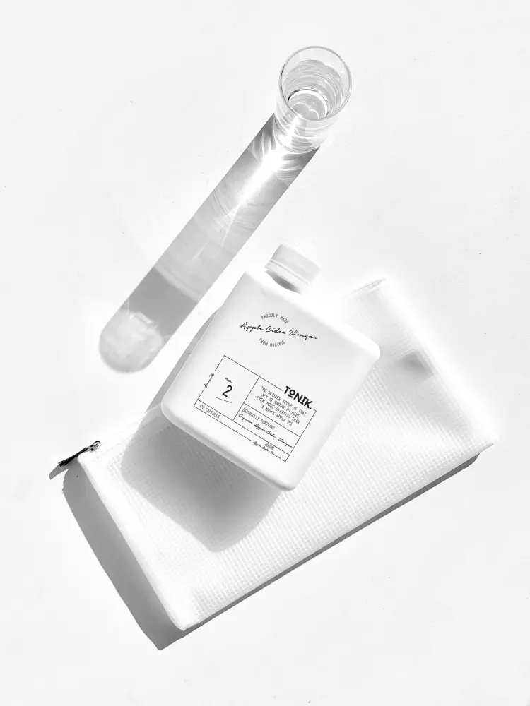 a bottle of lotion sitting on top of a napkin