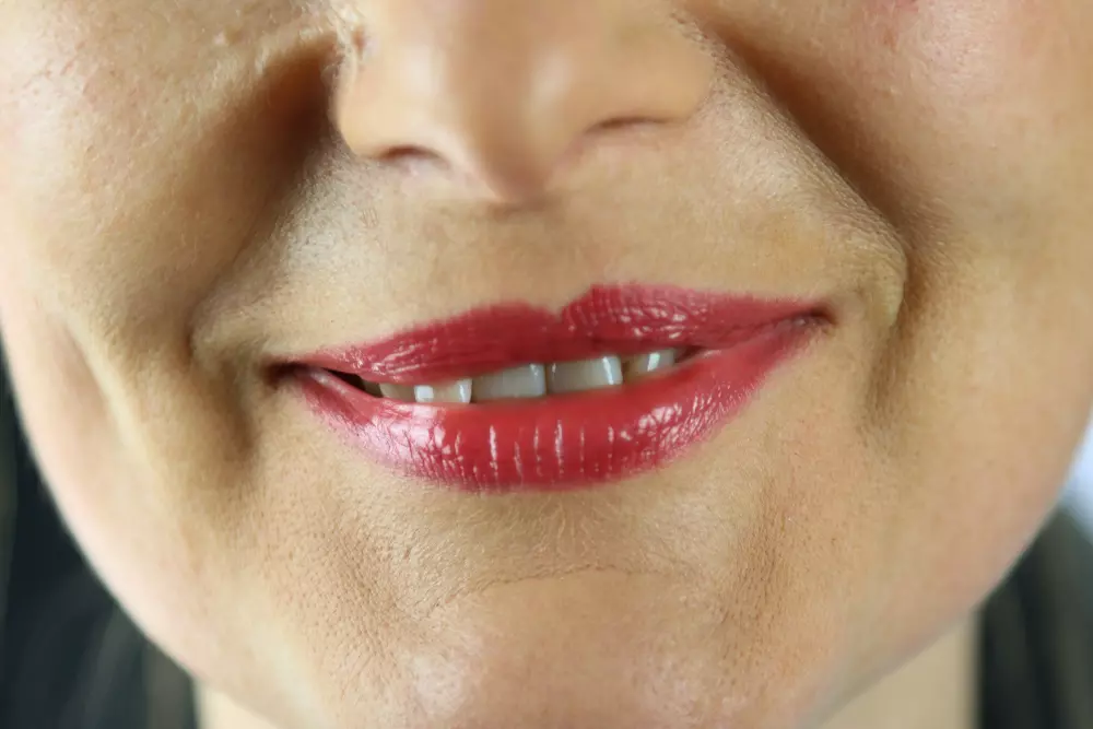 Eine Nahaufnahme des Gesichts einer Frau mit rotem Lippenstift