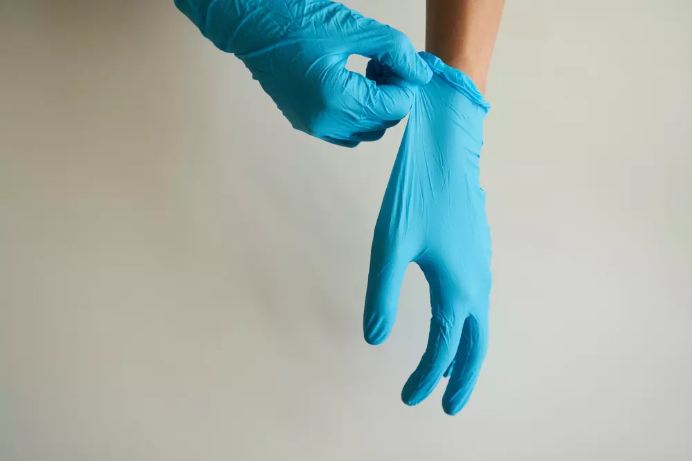 a pair of blue gloves on a person's hand