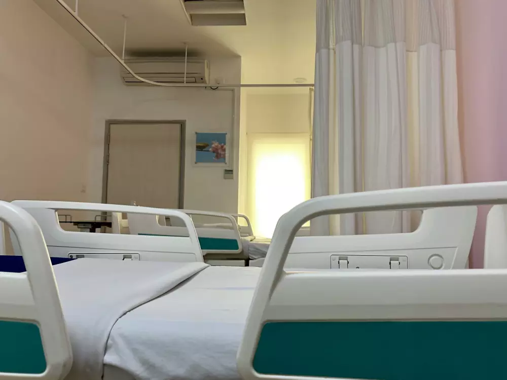 a hospital room with a bed and a mirror