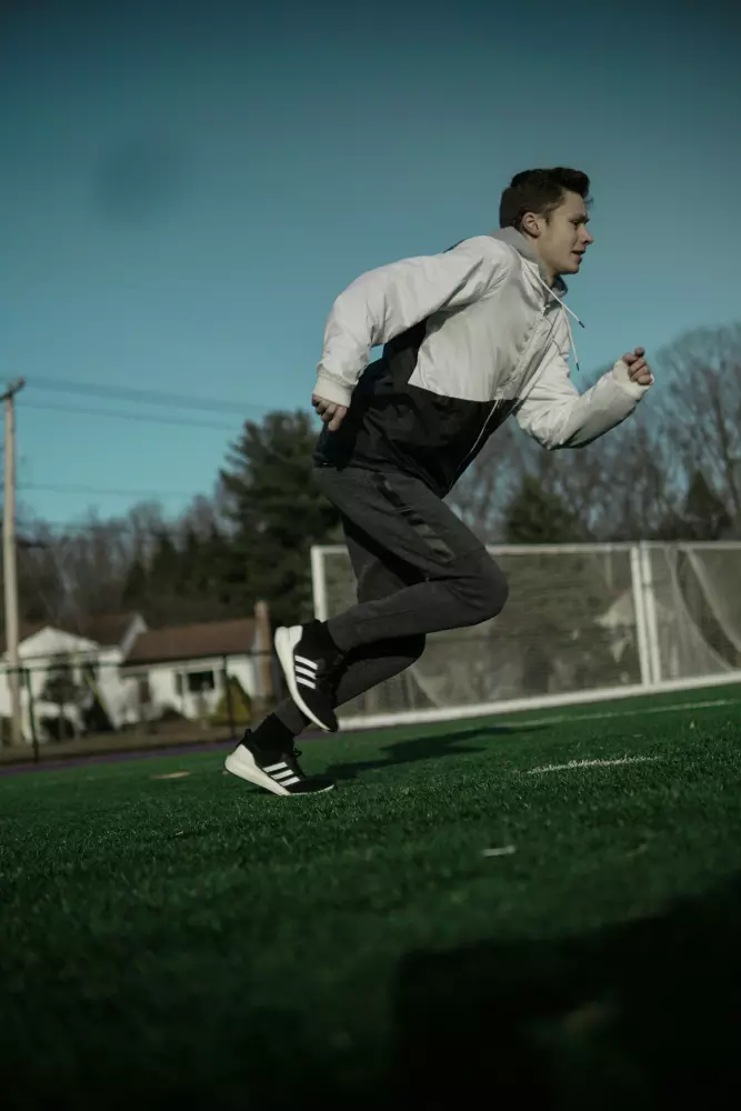 Ein Mann rennt über eine saftig grüne Wiese.