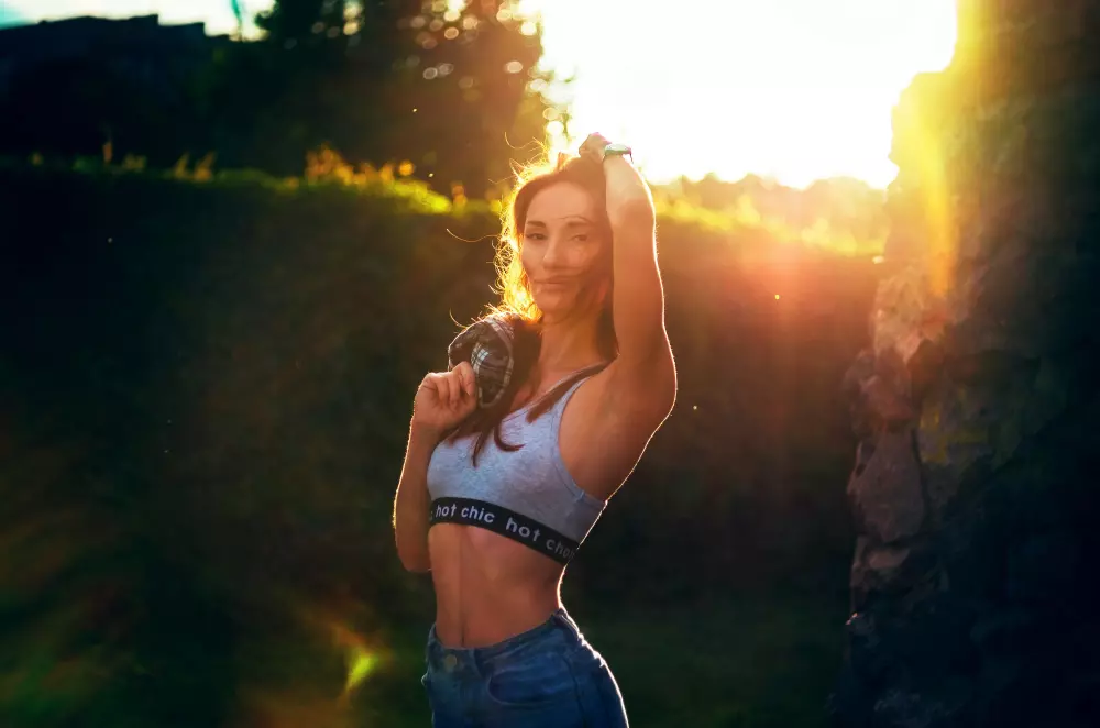 a woman holding a bottle in her right hand