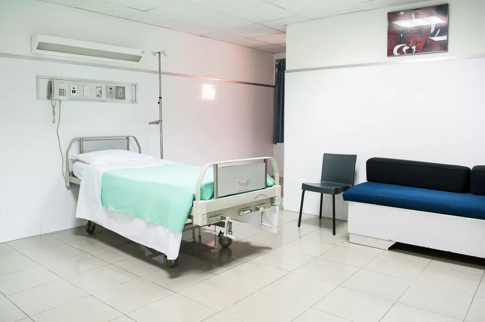 a hospital room with a bed and a couch