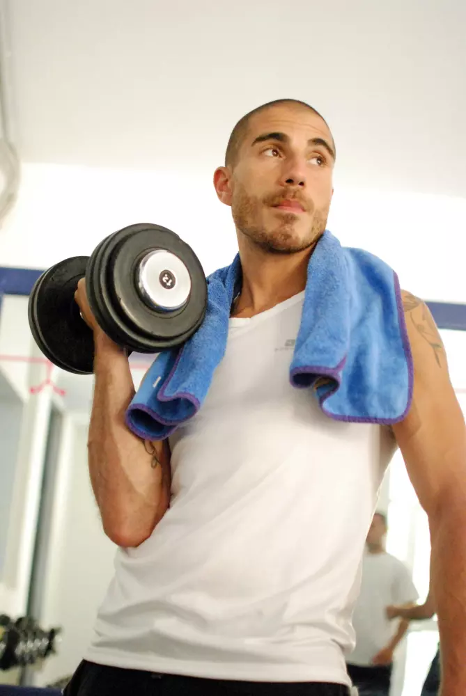 a man with a towel and a dumbbell