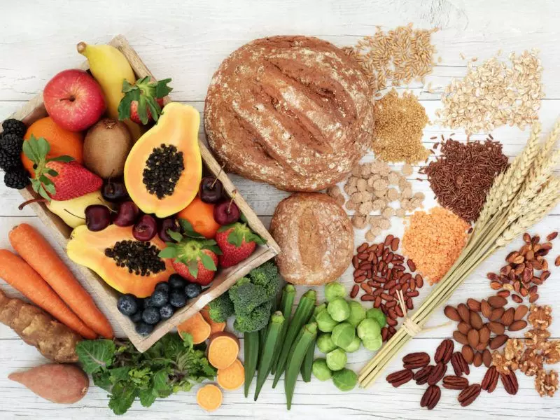 a variety of fruits and vegetables on a wooden table